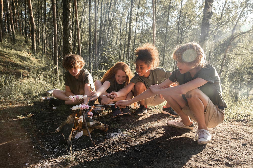 Camping-kids-roasting-marshmallows-over-campfire