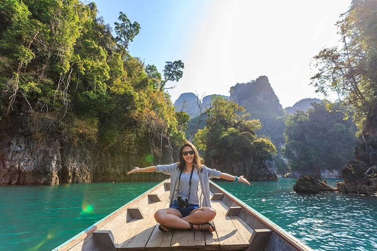 Rumble-Travel-Video-Ideas-happy-woman-in-canoe-with-camera.