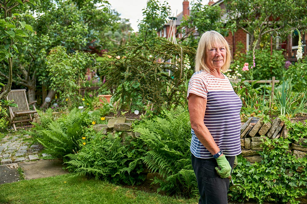gardening-smiling-senior-woman-working-in-green-garden